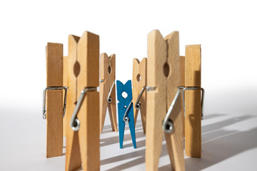Clothespins simulating a small child surrounded by people.