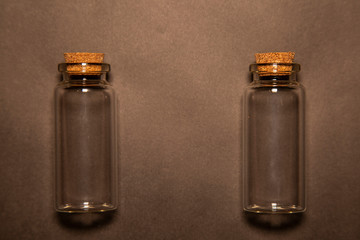 two poured glass containers on a black background