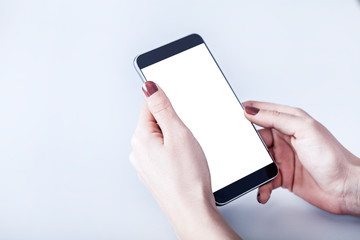 hand holding smart phone with blank screen