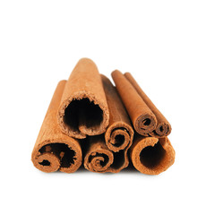Pile of cinnamon sticks end view isolated on white background. Spices for drinks and pastries.