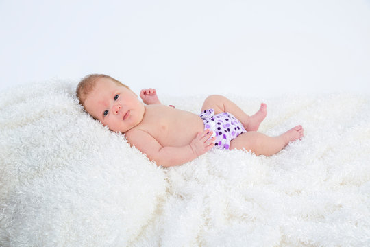 Baby photographed in the studio wearing a cloth diaper