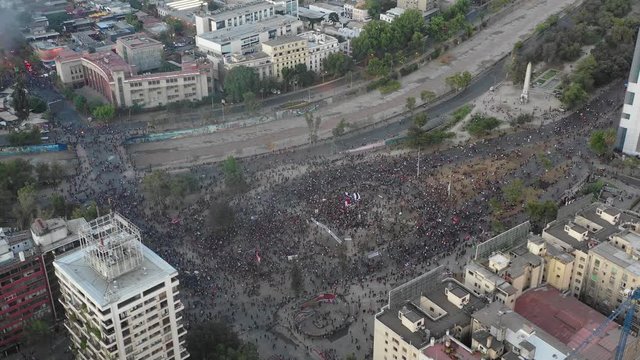 Aerial view of the center of Plaza Baquedano with thousands of protesters with Drone
