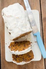 Carrot cake loaf with pecans, raisins and orange icing 