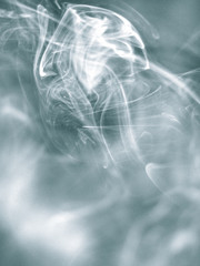 Pale blue abstract background - Trail of smoke on a dark background - creative colour effects with smoke smudges