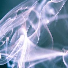 White and ocean blue abstract background - Trail of smoke on a dark background - creative colour effects with smoke smudges