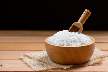 sea salt on wooden plate on wood table.