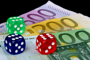 colored DICE on black background on the euro