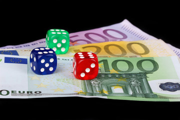 colored DICE on black background on the euro