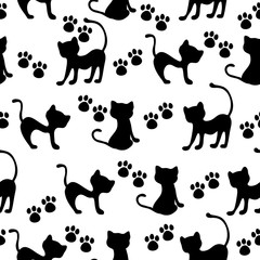 Hand-drawn black cats and paws vector seamless pattern	