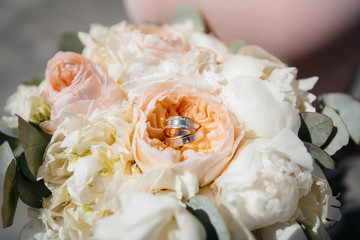 Wedding rings close-up on a beautiful wedding bouquet. Wedding accessories