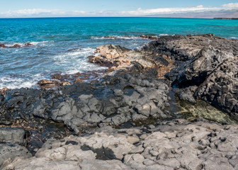 Fototapeta na wymiar Lava Covered Shoreline Of Kihola State Park Reserve With The Kohala Mountains In The Distance, Hawaii, Hawai,USA