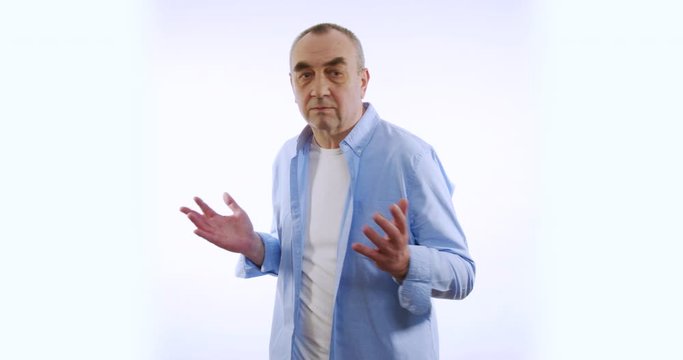 Mature man searching for something lost in pockets looking around. Isolated on white screen background.