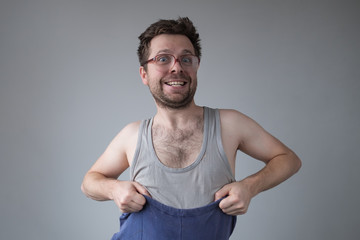 Untidy dressed man in big glasses smiling going crazy of self isolation at home.