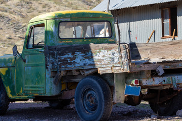 Fototapeta na wymiar Vintage green yellow truck with wood flatbed