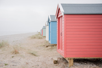 Findhorn, Scotland - July 2016: Colourful beach huts along the coast at Findhorn Bay in Northern...