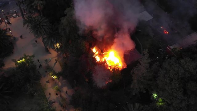 Take Air closer and at night from the fire to the church of Carabineros de Chile near Plaza Baquedano