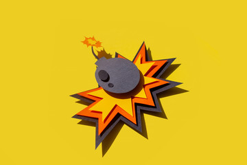 Handmade colorful paper cutting bomb. Pop art and comic style. On yellow background. 