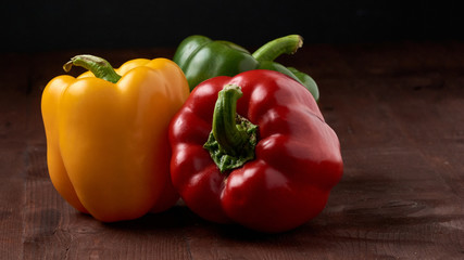 yellow,red,green, sweet bell pepper on wooden background
