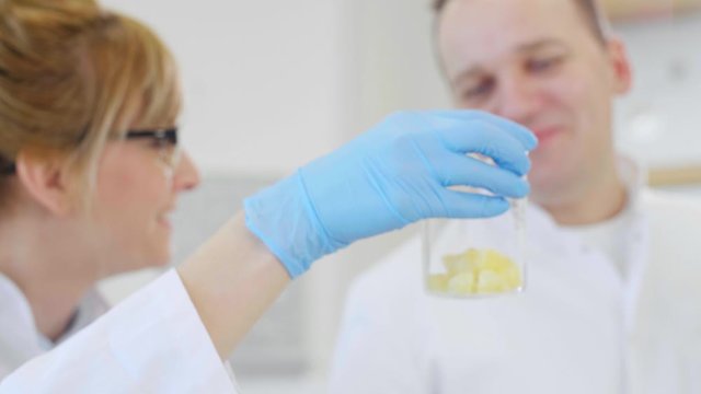 Close up of two scientists working with terpene crystals in laboratory
