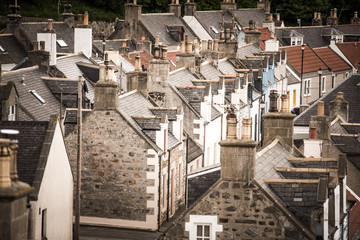 Old croft houses in Cullen, fishing village on Moray Firth, Scotland. Cullen Viaduct in the background, old roofs and chimneys © lukasz_kochanek