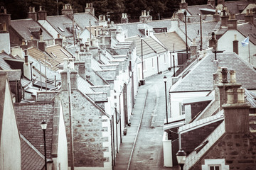 Old croft houses in Cullen, fishing village on Moray Firth, Scotland. Cullen Viaduct in the background, old roofs and chimneys © lukasz_kochanek