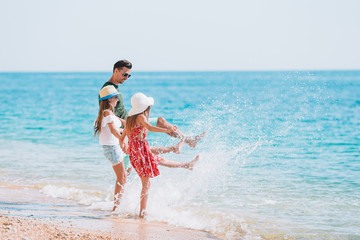 Adorable kids and their dad at beach during summer vacation - 339370177