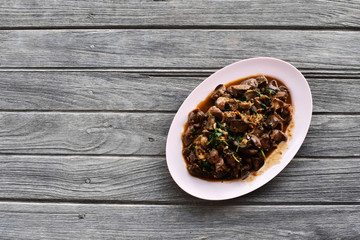 black pepper in a wooden bowl