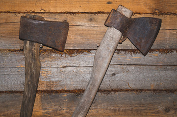 Old axes hangs on wooden wall. hand instrument. working tool