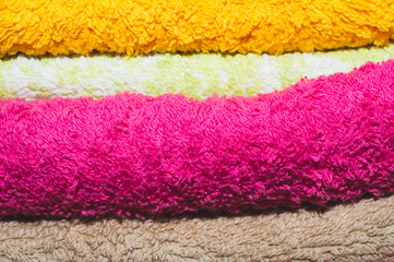 Heap of different colorful towels close up