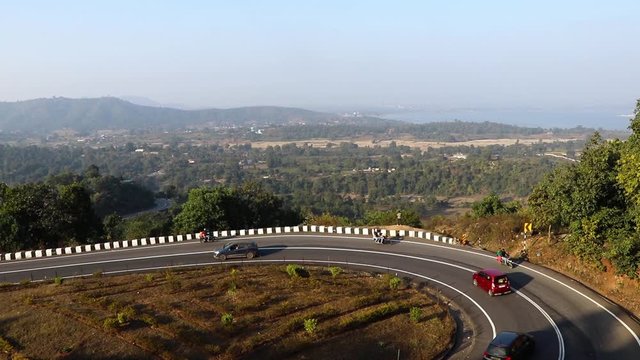 Patratu valley a clean n clear zig zag road in S or Z shape with lush greenery and sceneric views of hills across the way.
