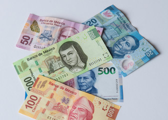 Money in banknotes or bills, Mexican money in a white surface, Mexican pesos or billetes en pesos.