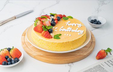 Happy birthday fresh fruit cheese cake with Happy birthday on cake concept with strawberry kiwi fruit cake. Food concept.