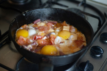 Cooking fried eggs in a pan