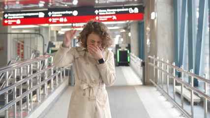 Young girl crying and waving goodbye to boyfriend in airport