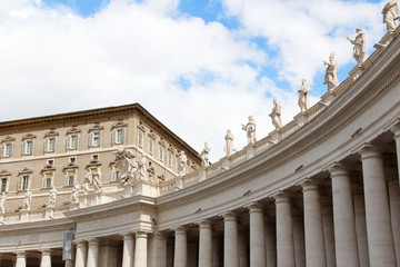 A group of Saint Statues on the colonnades of St Peter's Square with blue sky and clouds in Vatican City, Rome, Italy