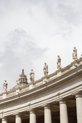 A group of Saint Statues on the colonnades of St Peter's Square with clouds in Vatican City, Rome, Italy