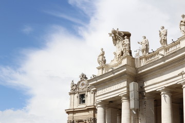A group of Saint Statues on the colonnades of St Peter's Square with blue sky and clouds in Vatican City, Rome, Italy