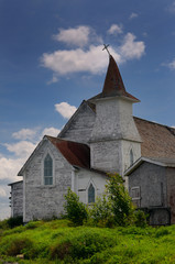Fototapeta na wymiar Anglican Christ Church with bent steeple and cross at Clarke's Head Gander Bay Newfoundland