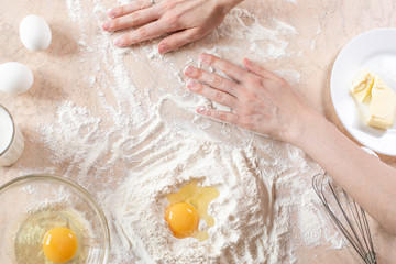 Kitchen table with ingredients for cooking baking. Copy space. Cooking concept. Eggs, flour on background. Dough ingredients.