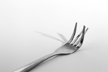 Fork and the shadow on white background