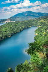 Obraz na płótnie Canvas lake serene blue water with misty mountains aerial image