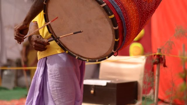 Shot of Dhak dhol or drum played with dance during Durga Puja or Durgotsava, is an annual Hindu festival celebrated by Bengali, Odia, Maithils & Assamese communities festivity