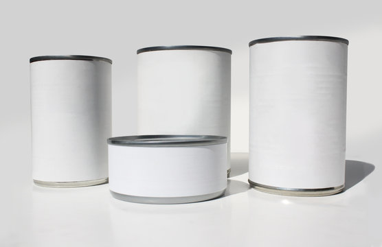 Tins of food with blank labels isolated on white.
