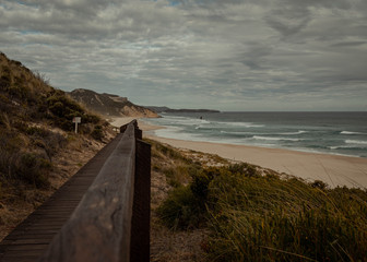 Picture of a wooden path leading to a remote beach in Western Australia. Surrounded by bush and hills, this place feels like a deserted island