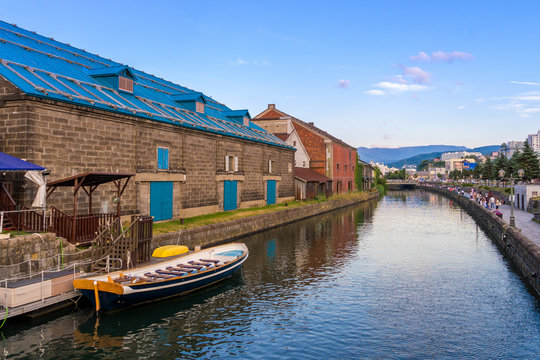 View of Otaru canal with tourist boat and blue sky in Summer in Otaru, Hokkaido, Japan. It a historic canal in Otaru city where is a popular tourist destination. 