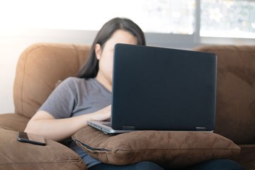 Asian women use laptop working at home for protect COVID-19
