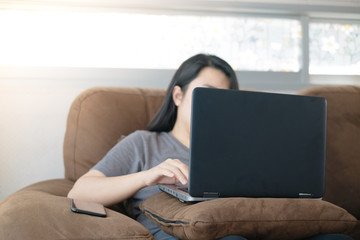 Naklejka premium Asian women use laptop working at home for protect COVID-19