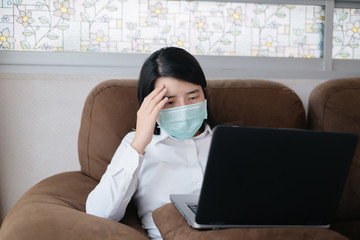 Sick Asian women wearing surgical mask for protective COVID-19 and Coronavirus in working from home