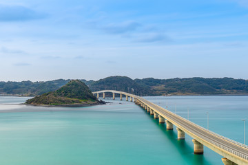 Fototapeta na wymiar Perspective view of Tsunoshima Ohashi Bridge in Shimonoseki with a long exposure. The bridge located off the northwest coast of Yamaguchi Prefecture by the Sea of Japan.