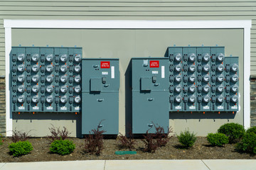 Power meters on multi-unit residential  building wall